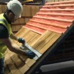 Miramar Roofing worker installing wood roof shingles