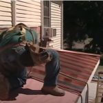 Roofing workers installing aluminum roof