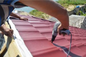 Roofing contractors installing metal roof